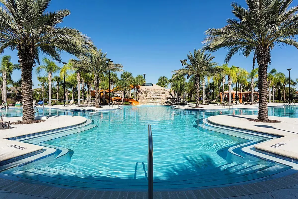 Zero-entry resort pool with palm trees at Solterra Resort